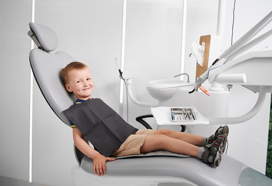 Cute Male Child Sitting In Dental Chair In Modern Clinic. Adorab Emerald Dental - Pediatric Dentistry